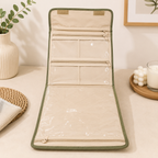 Cream satin foldable jewellery organizer with green embroidery, transparent zip pockets, carry handle, and dimensions 27 × 29 × 6 cm
