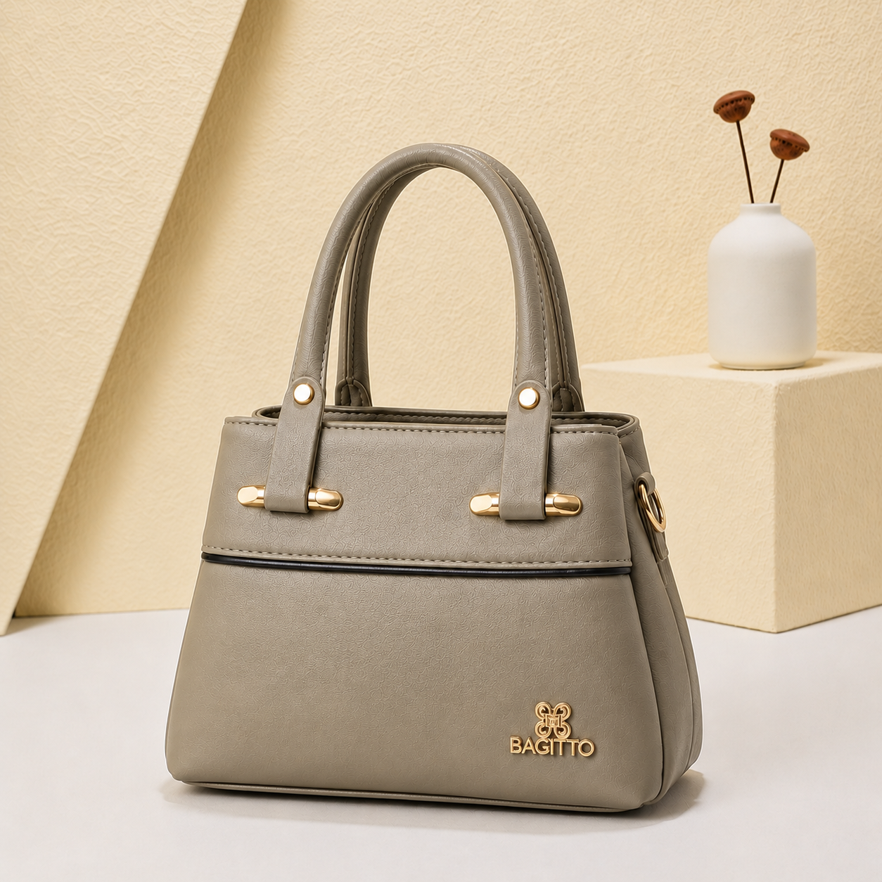 Ravia grey structured handbag for women with gold hardware displayed in a premium minimalist studio setting